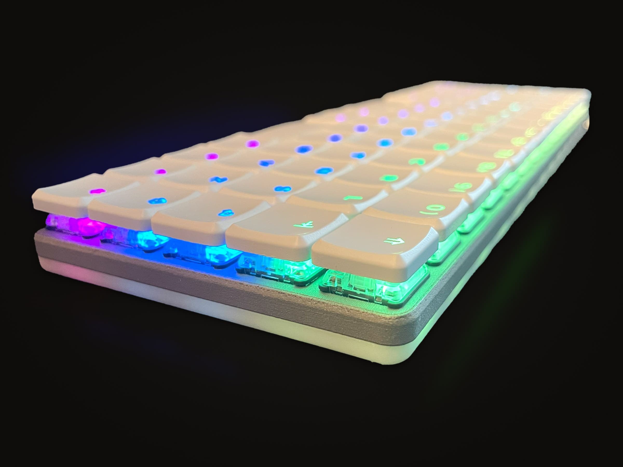 KeBe v1 from a low angle at one end, the RGB glowing through its switches.